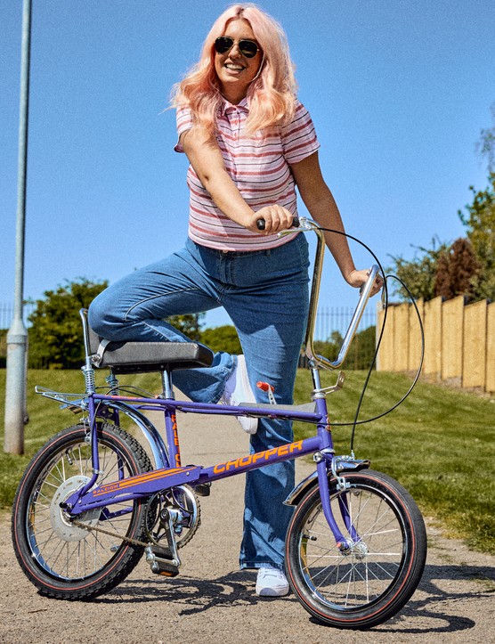 Woman posing with purple Raleigh Chopper.