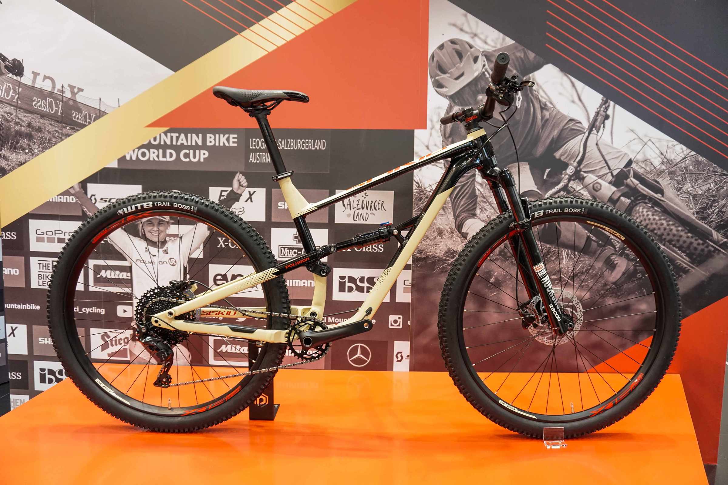 cream and black full suspension mountain bike
